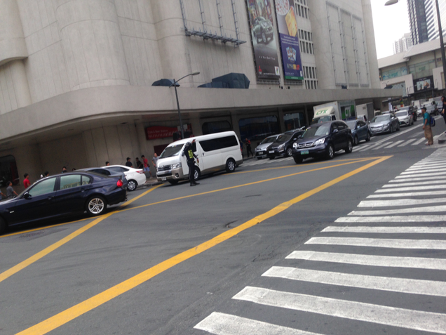 Traffic enforcers at work in the Makati CBD. Stoplights are here, but Traffic enforcers are needed to control box blockers